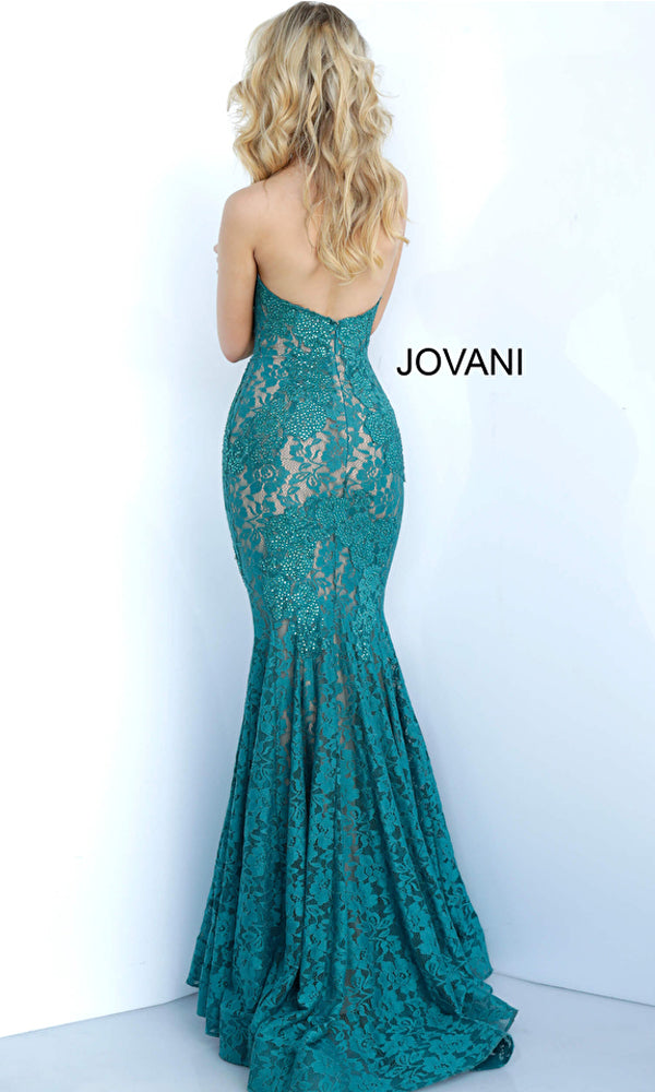 A woman with long blonde hair models the Long Prom Dress 37334 by Jovani, a strapless teal lace gown with a sweetheart neckline and fitted bodice, standing against a plain white background. The image displays the